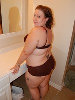 Tattoed bbw milf slowly taking off her undies in front of a cam.
