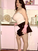 Big hottie takes off her flesh colored top then pink and brown bra and bares her huge breasts in her kitchen.