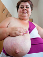 Old fat slut with gigantomastia gets naked